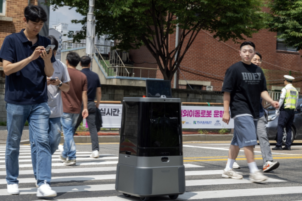 현대차·기아 자율주행 배송로봇이 시민과 함께 횡단보도를 횡단하는 모습. (사진=현대자동차그룹)