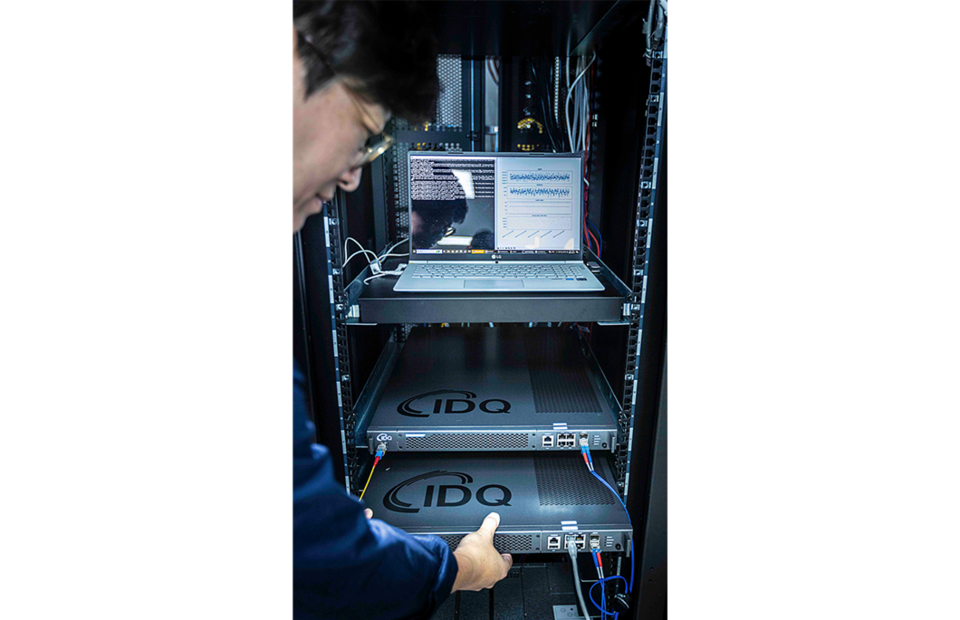 SKT와 QKD 제품 보유기업인 아이디퀸티크 구성원들이 해당 제품을 테스트하는 모습. (사진=SKT)